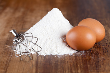 Image showing eggs, flour and whisk