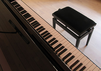 Image showing Black piano and music stool