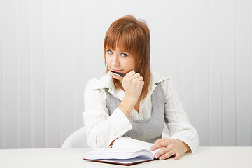 Image showing business girl with notebook and pen