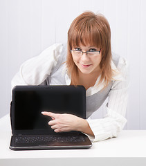 Image showing girl shows a finger on a laptop