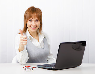 Image showing attractive girl with a thumb up in the office