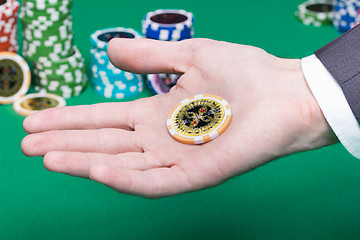Image showing poker chips in the palm of a man
