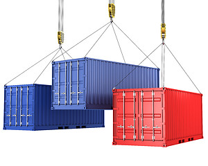 Image showing Three freight containers are being hoisted