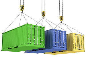 Image showing Three freight containers are being hoisted