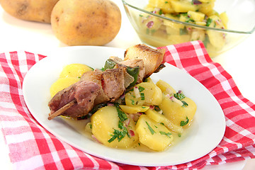 Image showing Shashlik skewer with potato salad