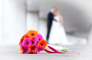 Image showing Bride and groom with weddings bouquet in front