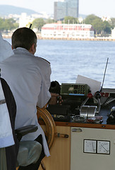 Image showing Ferry captain sitting at the wheel