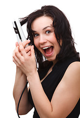 Image showing Woman is screaming while using hair straightener