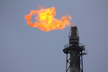 Image showing torch is lit on tower refinery