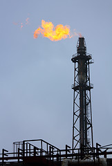 Image showing torch is lit on tower refinery