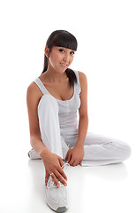 Image showing Beautiful smiling woman sitting on the floor