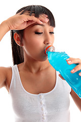 Image showing Exhausted girl drinking after fitness workout