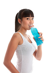 Image showing Attractive girl drinking sports drink after exercise