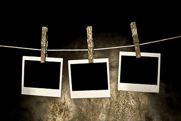 Image showing classic old polaroid photo Held By Clothespins 