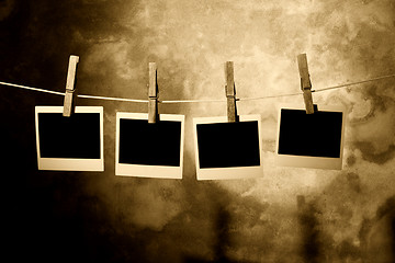 Image showing  polaroid photo Held By Clothespins 