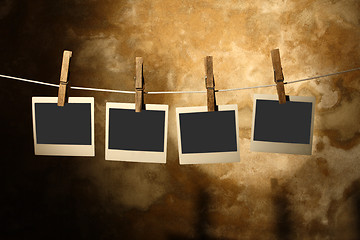 Image showing  polaroid photo Held By Clothespins 