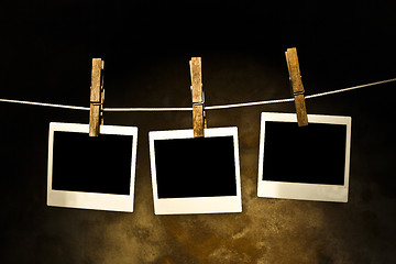 Image showing classic old polaroid photo Held By Clothespins 