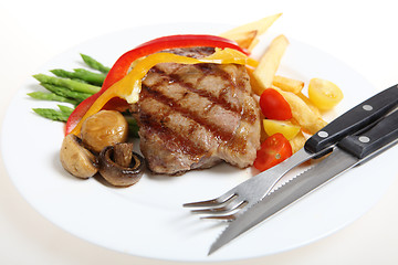 Image showing Veal steak meal with cutlery