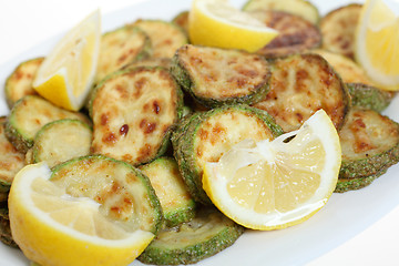 Image showing Fried courgette rings and lemon macro