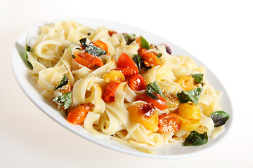 Image showing Tagliatelle and tomatoes slanted