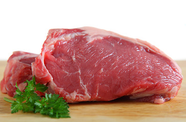 Image showing Veal sirloin steaks on a board