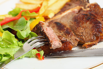 Image showing Eating T-bone steak