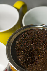 Image showing can of ground coffee beans with mugs