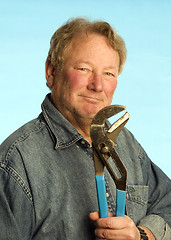 Image showing smiling happy contractor builder homeowner with tool