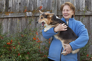 Image showing old woman with corgi puppy