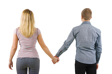 Image showing A young couple holding hands, back to camera