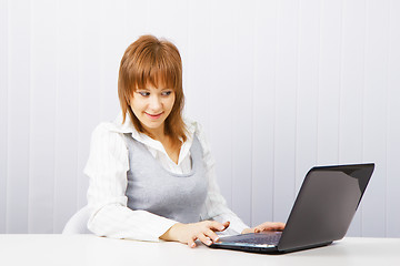 Image showing girl with surprise stares at the monitor laptop