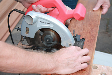 Image showing construction worker cutting wood 