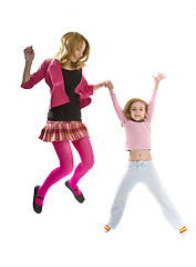 Image showing Happy sisters jumping together