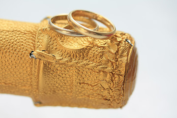 Image showing wedding bands on champagne