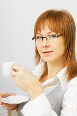 Image showing attractive girl in the office with a cup of coffee