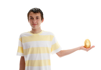 Image showing Boy holding a golden easter egg