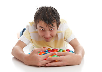 Image showing Boy hoarding easter eggs