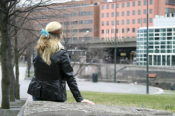 Image showing Woman Sitting in City