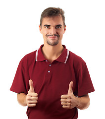 Image showing young man thumb up and smiling isolated on white