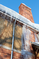 Image showing Icicles Hanging From A Drainpipe On A rural House