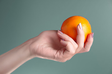 Image showing woman holds in her hand oranges