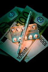 Image showing Banknotes with pills blister and thermometer