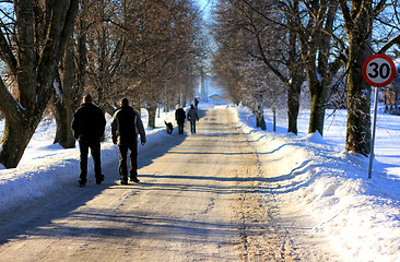Image showing People walking in a winter road.