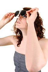 Image showing Girl looking trough sunglasses.