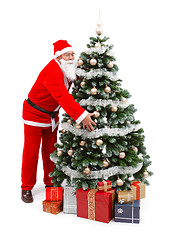 Image showing Santa Claus holding Christmas tree