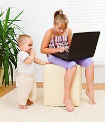 Image showing Sister and brother with computer