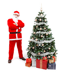 Image showing Santa Claus standing near Christmas tree