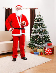 Image showing Santa Claus standing in front of Christmas Tree