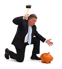 Image showing Business man breaking piggy bank