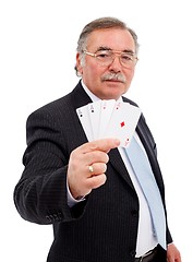 Image showing Senior man showing the four aces